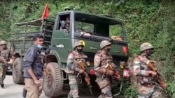 This image from video shows Indian army soldiers arriving at the site after an army helicopter carrying India's Chief of Defense Staff Bipin Rawat crashed near Coonoor, Tamil Nadu state, India, Dec. 8, 2021.