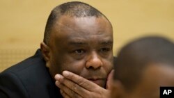 FILE - Former Congo vice-president Jean-Pierre Bemba looks up at his trial at the International Criminal Court in The Hague, Netherlands, Sept. 29, 2015.