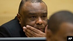 FILE - Former Congo vice-president Jean-Pierre Bemba looks up at his trial at the International Criminal Court in The Hague, Netherlands, Sept. 29, 2015.