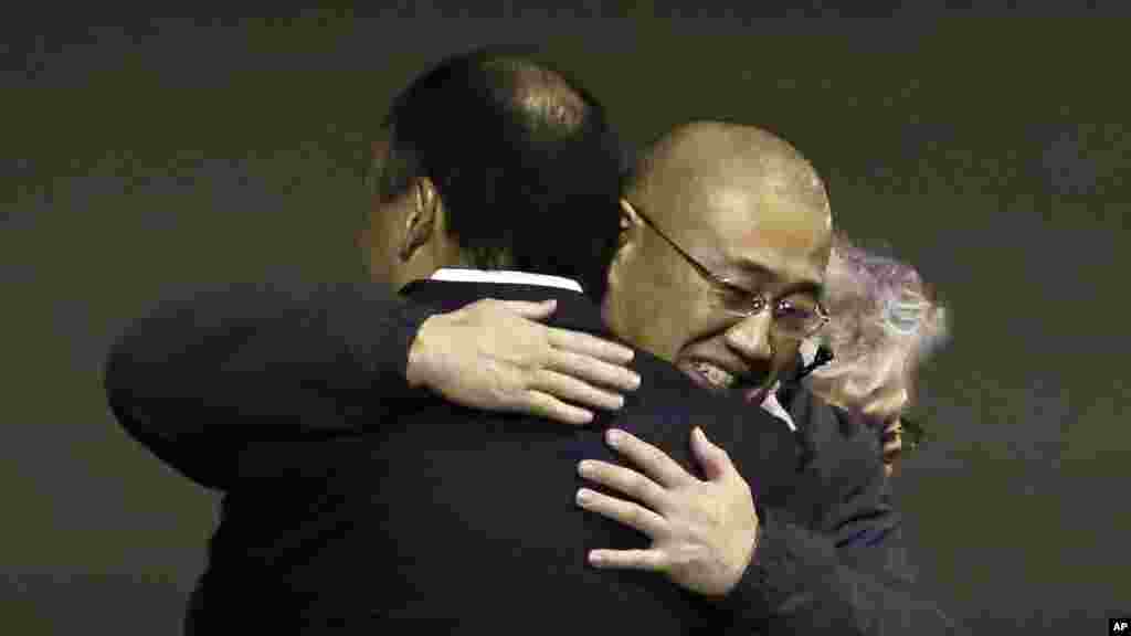 Kenneth Bae, center, who had been held in North Korea since 2012, is hugged after arriving at Joint Base Lewis-McChord, Washington, Nov. 8, 2014.