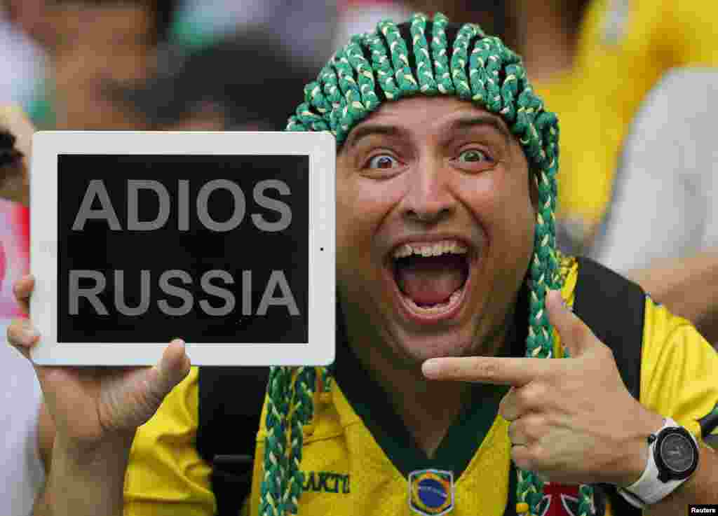 A spectator holds up a message for Russia before the start of the 2014 World Cup Group H soccer match against Belgium at Maracana stadium in Rio de Janeiro, Brazil.
