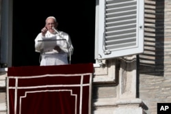 Pope Francis gestures during the Angelus noon prayer in St. Peter's Square at the Vatican, Dec. 17, 2017.