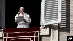 Pope Francis gestures during the Angelus noon prayer in St. Peter's Square at the Vatican, Dec. 17, 2017. 