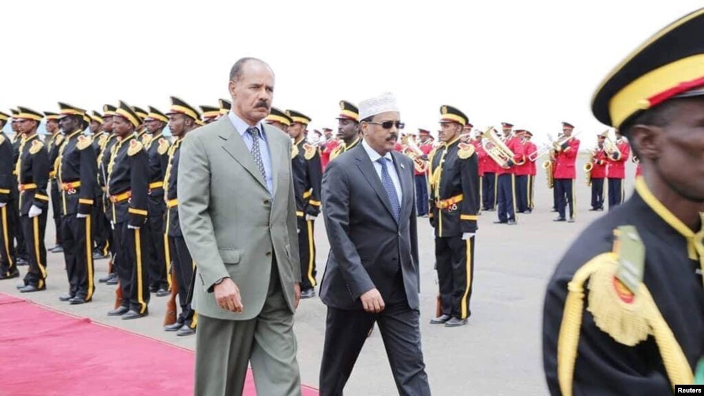 FILE - Eritrea's President Isaias Afwerki, left, walks beside Somalia's President Mohamed Abdullahi Mohamed during a welcoming ceremony upon his arrival for a three-day visit to Eritrea, in Asmara, Eritrea, July 28, 2018.