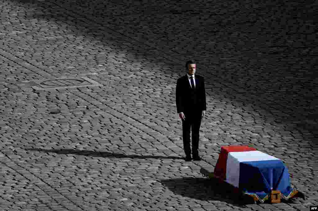 French President Emmanuel Macron stands in front of the coffin of former French president Jacques Chirac during a military tribute at the Hotel des Invalides in Paris.