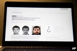 The website of the British investigative group Bellingcat showing alleged photos of Col. Anatoliy Chepiga is seen on a computer screen in Moscow, Russia, Sept. 27, 2018.