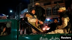 Afghan security personnel arrive near the Serena hotel, during an attack in Kabul, March 20, 2014.