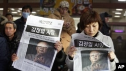 South Koreans read extras reporting the death of North Korean leader Kim Jong Il at the Seoul train station in Seoul, South Korea, Monday, Dec. 19, 2011. Kim Jong Il, North Korea's mercurial and enigmatic leader, has died. He was 69. The headline read "Th