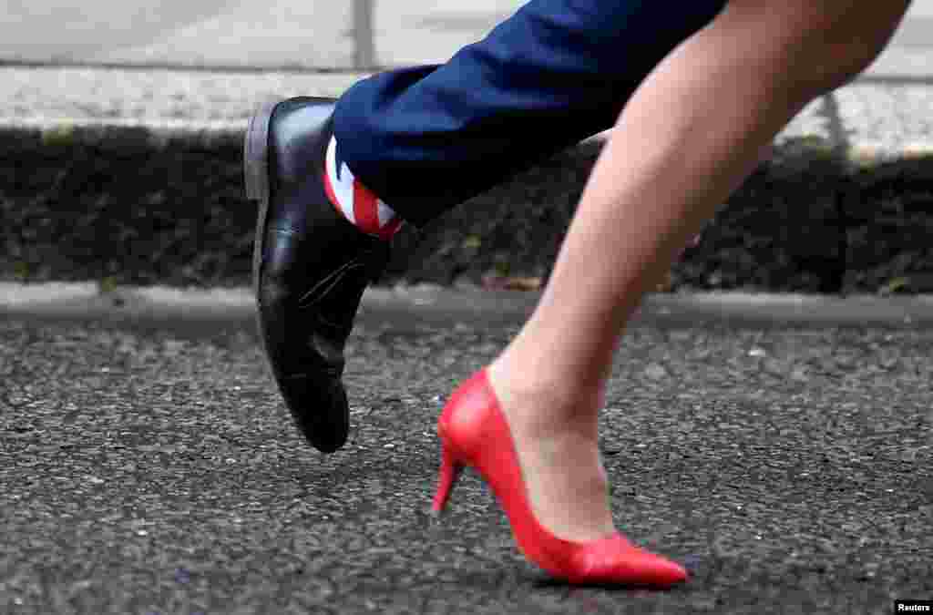 Britain's Health and Social Care Secretary Matt Hancock wears Union Jack socks as he leaves with Leader of the House of Lords Baroness Evans after a cabinet meeting on Downing Street in London.