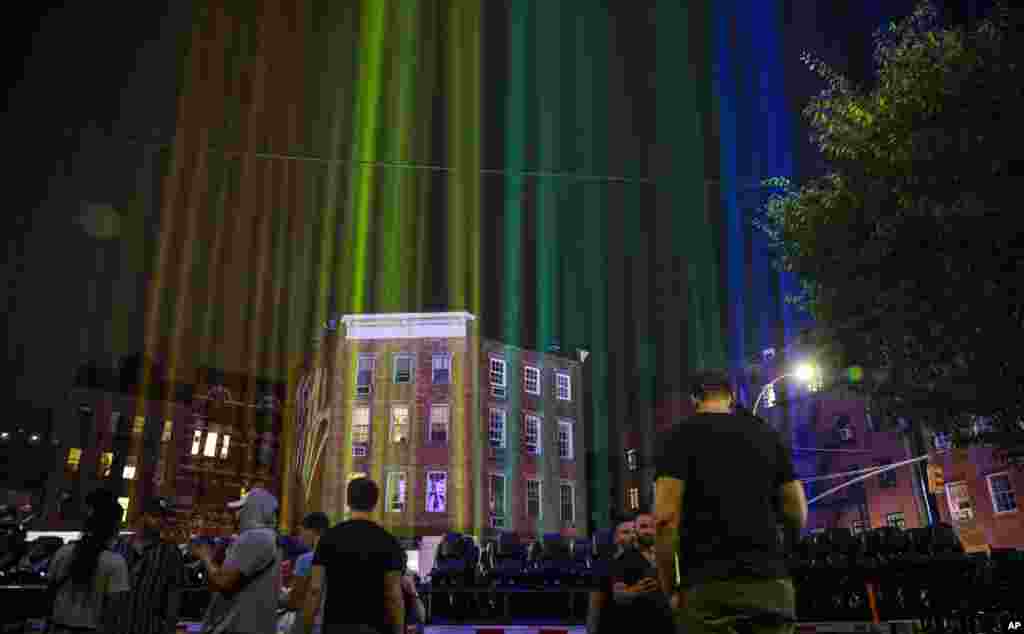A rainbow light display illuminates the night sky in the West Village near The Stonewall Inn, birthplace of the gay rights movement, June 27, 2020, in New York.