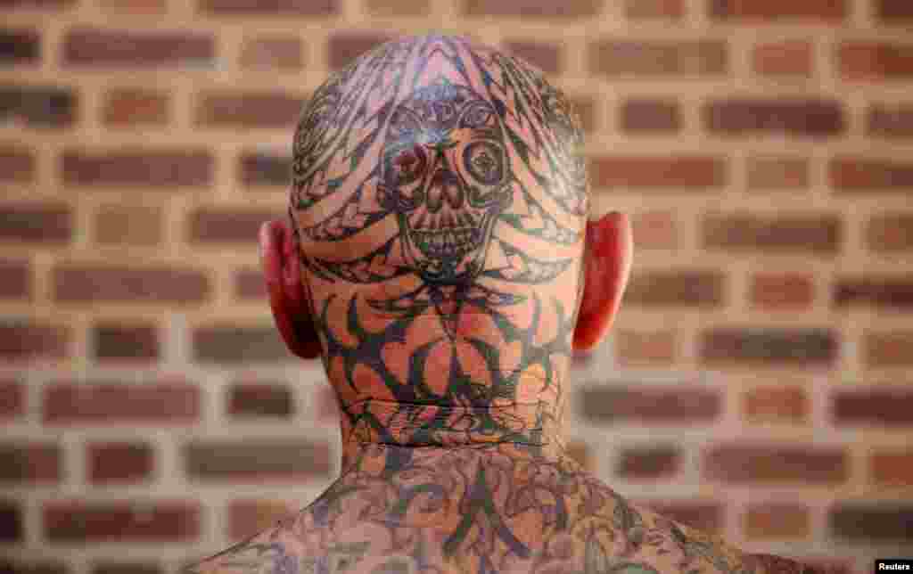 A tattoo enthusiast poses at the International London Tattoo Convention in London, Britain.