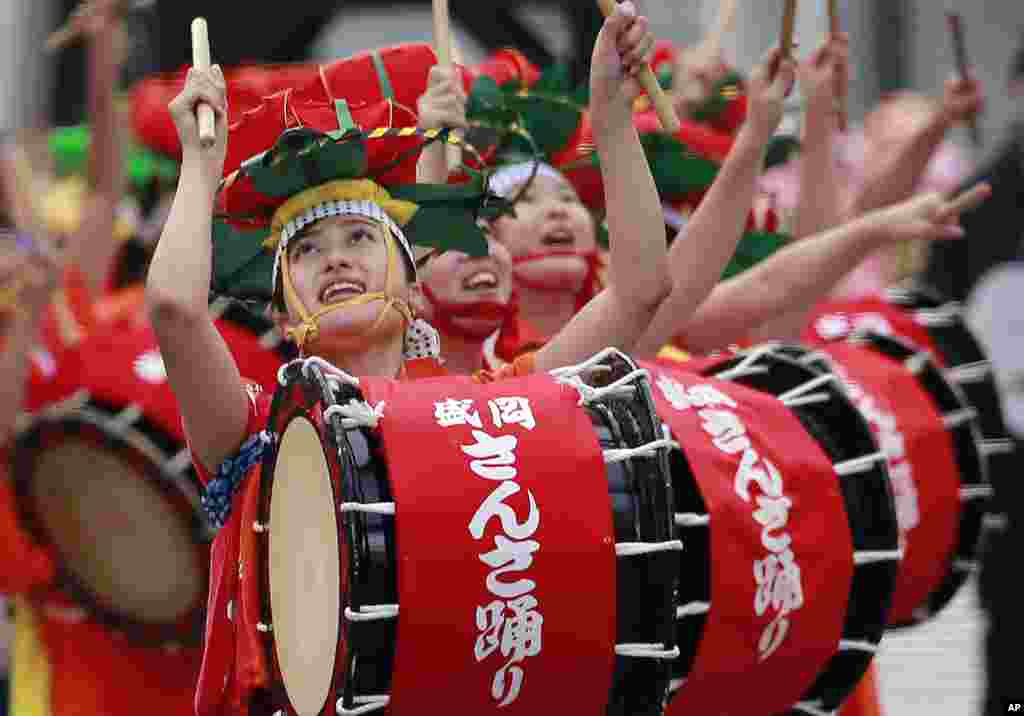 Dancers sing and play drums during the Morioka Sansa Festival performance at Shintora Festival on the street in Toranomon business district in Tokyo, Japan.