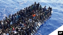 This Sunday, June 24, 2018 photo released by the Libyan Coast Guard shows migrants on a ship intercepted offshore near the town of Gohneima, east of the capital, Tripoli. 