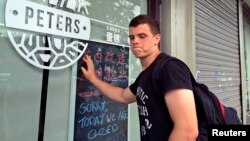 Peter Garratt, one of the sons of Canadian couple Kevin and Julia Dawn Garratt, who are being investigated in China for threatening national security, stands outside his parents' coffee shop as he talks to Reuters journalists in Dandong, Liaoning province