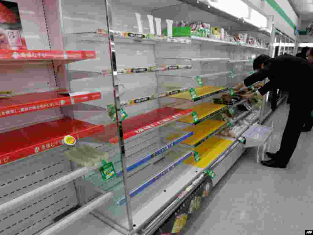 A man looks for supplies in a store in Tokyo that has almost sold out of food and drink as people are unable to return home after an earthquake March 11, 2011.