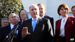 Rep. Steve Scalise, R-La., center, together with Rep. Kevin Brady, R-Texas, left, and Rep. Cathy McMorris Rodgers, R-Wa., right, and other Republicans speaks to reporters outside the West Wing of the White House following a meeting with President Trump, Washington, March 26, 2019