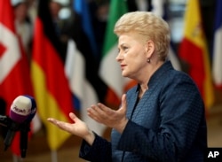 Lithuanian President Dalia Grybauskaite speaks with the media as she arrives for an EU summit in Brussels, Oct. 17, 2018.