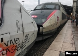 FILE - A tag on a TGV high-speed train reads "long live the strike" at the Gare du Nord railway station in Paris, France, March 23, 2018.