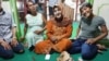 Ibu Shinta (center) is seen surrounded by students at Indonesia's only Islamic school for transgender students, which she runs out of her house in Yogyakarta. (K. Varagur/VOA)