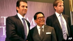 FILE - Philippines Trump TowerDonald Trump Jr., left, and Eric Trump, right, sons of Donald Trump, pose with local developer Jose E. B. Antonio at the launching of Manila's Trump Tower project June 26, 2012 in the Philippines.