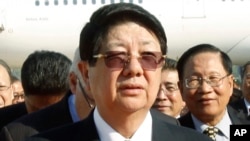 In this March 31, 2011, file photo, Cambodian Deputy Prime Minister Sok An walks at Phnom Penh International Airport in Phnom Penh, Cambodia.