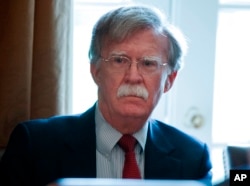 FILE - National Security Adviser John Bolton listens as President Donald Trump speaks during a cabinet meeting at the White House in Washington, April 9, 2018.