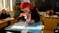 A woman casts her vote in Sintesti, Romania, Dec. 11, 2016.