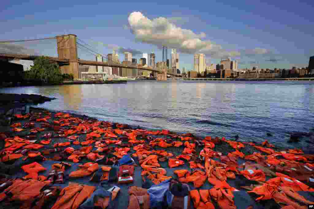 Advocates with Oxfam America place hundreds of life jackets on the ground along the New York City waterfront in Brooklyn to draw attention to the refugee crisis. Many of the life jackets had been used by adult and child refugees and collected on the beaches in Greece.