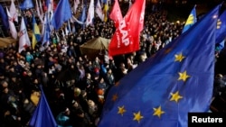 FILE - People attend a meeting to support EU integration at European square in Kyiv, Ukraine, Nov. 25, 2013.