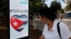 A woman passes by a screen displaying images promoting the vote for "yes" for the constitutional referendum, in Havana, Cuba, Feb. 5, 2019. 