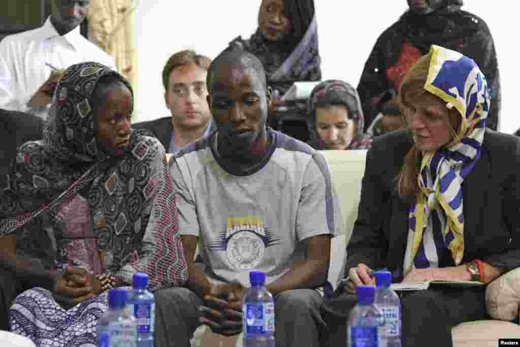 At the Grand Mosque, U.S. Ambassador to the United Nations Samantha Power meets with Ebola survivors Fanta Oulen Camara, 24, left, and Dr. Oulare Bakary, 30, center, in Conakry, Guinea Oct. 26, 2014.