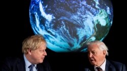 FILE - British Prime Minister Boris Johnson and David Attenborough speak with school children during a conference about the COP26 UN Climate Summit, at the Science Museum in London, Feb. 4, 2020. (Chris J Ratcliffe/Pool via Reuters)