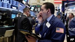 Trader Tommy Kalikas works on the floor of the New York Stock Exchange, March 30, 2017. 