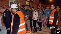 Arab league observers wearing orange vests oversee the releasing of Syrian prisoners who wait in queue to be released from Adra Prison on the outskirts of Damascus, January 15, 2012