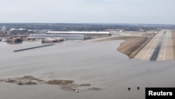 FILE - Offutt Air Force Base and the surrounding areas affected by flood waters are seen in this aerial photo taken in Nebraska, March 16, 2019.