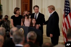 FILE - President Donald Trump applauds Judge Brett Kavanaugh, his Supreme Court nominee, in the East Room of the White House, July 9, 2018, in Washington.