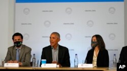 Former U.S. President Barack Obama sits next to Nima Tisdall from Denmark, right, and Rachid Ennassiri from Morocco during a roundtable meeting at the COP26 U.N. Climate Summit in Glasgow, Scotland, Nov. 8, 2021.