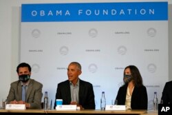 Former U.S. President Barack Obama sits next to Nima Tisdall from Denmark, right, and Rachid Ennassiri from Morocco during a roundtable meeting at the COP26 U.N. Climate Summit in Glasgow, Scotland, Nov. 8, 2021.