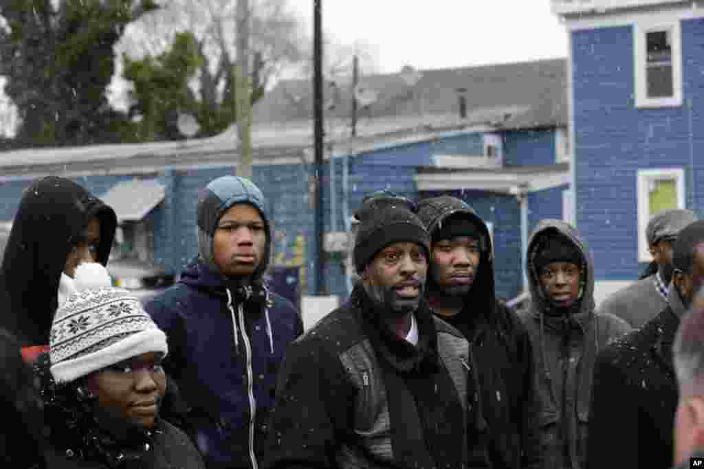 People listen during a news conference after police dashboard camera footage was released from the Dec. 30, 2014 shooting of Jerame Reid during a traffic stop, Bridgeton, N.J., Jan. 21, 2015.