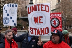 Plumbers workers union members rally at City Hall Park in New York City, December 15, 2021.