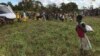 A boy watches the distribution of aid materials in the remote village of Bopira, Mozambique, April 6, 2019. 