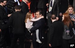 Republican presidential candidate, Sen. Ted Cruz, R-Texas, holds his daughter after the Fox Business Network Republican presidential debate at the North Charleston Coliseum, in North Charleston, S.C., Jan. 14, 2016.