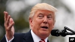 President Donald Trump speaks on the South Lawn of the White House in Washington. 