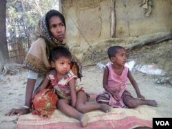 Rohingya refugee Arofa Begum and her two children at a Rohingya refugee colony in Cox's Bazar, Bangladesh. After Begum's husband and 15-year-old son was burnt alive by the Burmese soldiers, she fled to Bangladesh with her two children in December. "There is no adult male in my family. I will be at sea if I am forced to relocate to Thengar Char island. Although life is very risky for all Rohingyas in Myanmar, with my children I have no other option except going back to our home country," Begum told VOA. (Photo: S. Islam for VOA)