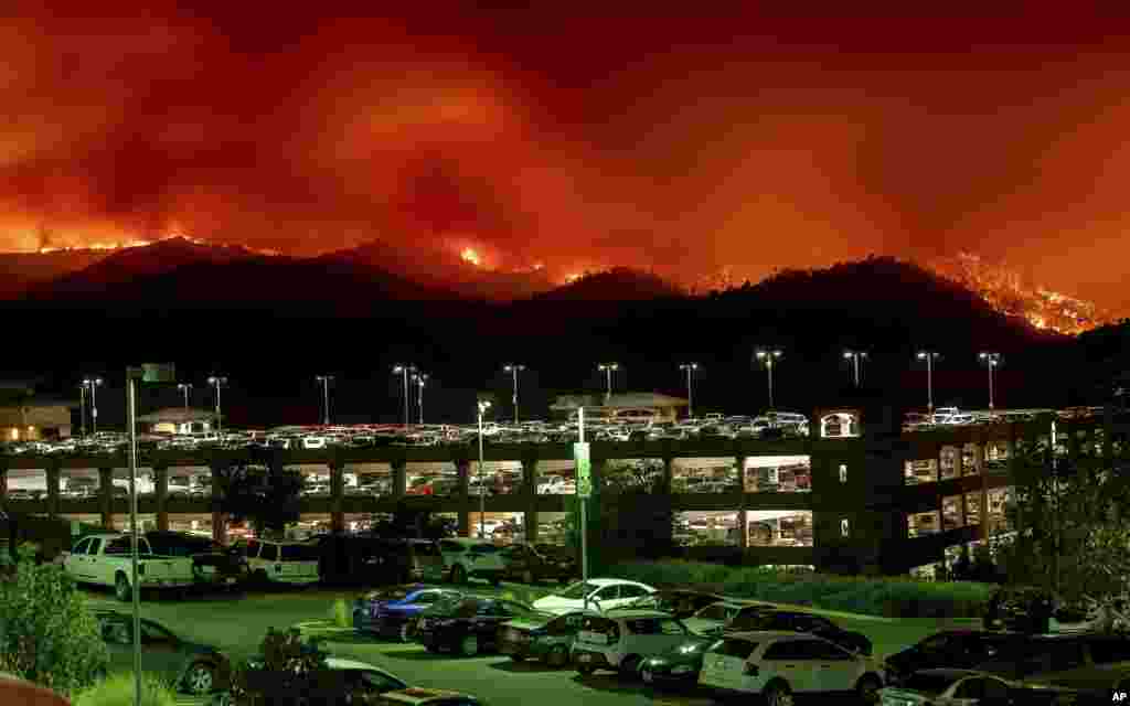 Flames from the County fire burn above Cache Creek Casino Resort in Capay, California, June 30, 2018.