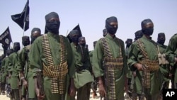 Al-Shabab fighters on parade with their guns during military exercises on the outskirts of Mogadishu,Somalia (File Photo - February 17, 2011)