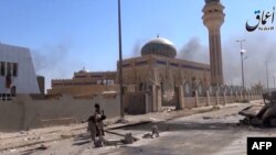 File - An image grab taken from a video allegedly shows Islamic State fighters in a street of Ramadi, Iraq. 