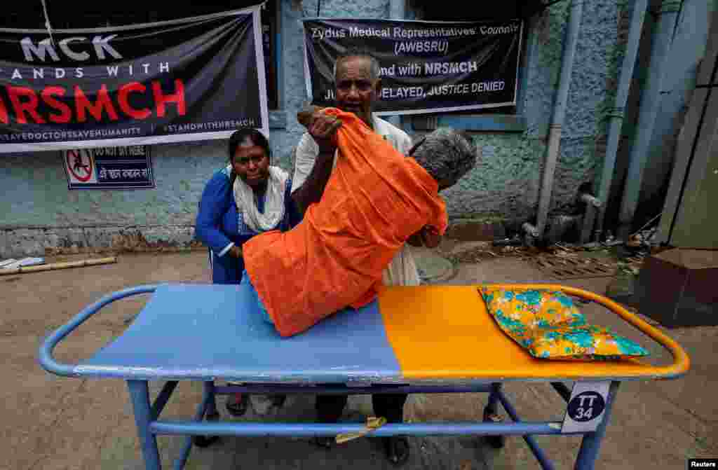 A patient leaves after failing to get treatment at a government hospital during a strike by doctors demanding security following the recent assaults on doctors by patients' relatives, in Kolkata, India.