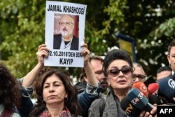 FILE - President of Human Right Association (IHD) Eren Keskin, right, speaks to journalists during a demonstration in front of the Saudi Arabian consulate in Istanbul, in support of missing journalist and Riyadh critic Jamal Khashoggi, Oct. 9, 2018.
