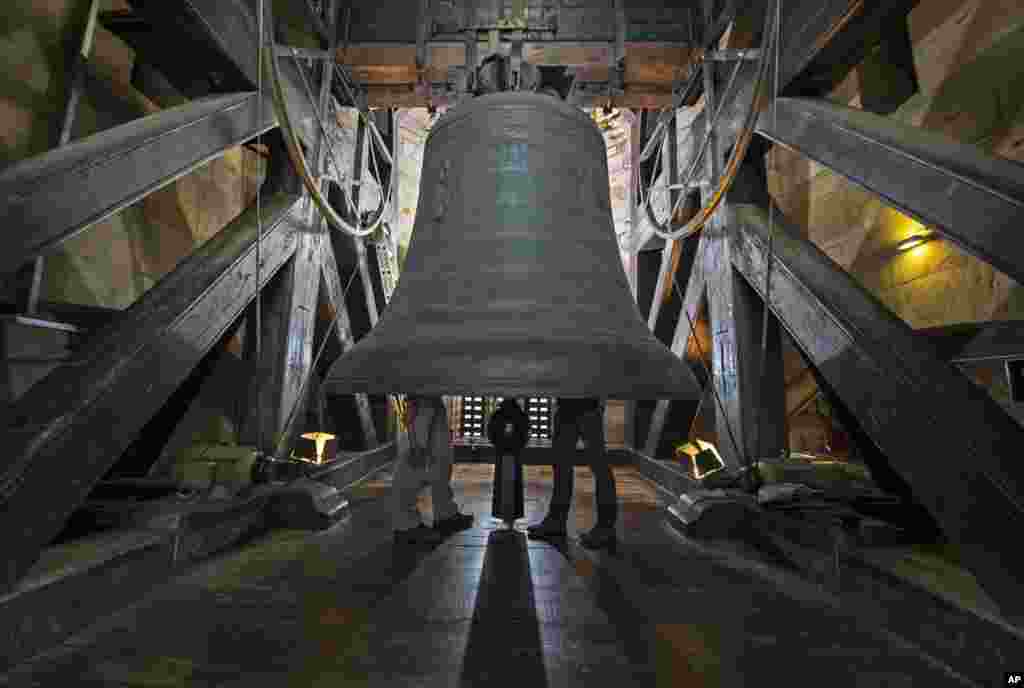 Workers inspect the Gloriosa bell during annual planned maintenance in the Mariendom (Cathedral of Mary) in Erfurt, central Germany.